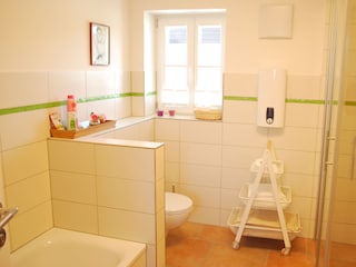 Bathroom with bath tub, shower, washing machine, dryer