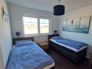 Second bedroom with 2 single box spring beds