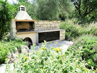 there is a charcoal grill and a gas grill